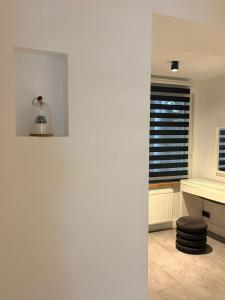 a white room with a desk and a window at Brussels Loft in Brussels +18 photos
