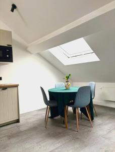 a dining room with a green table and chairs at Brussels Loft in Brussels