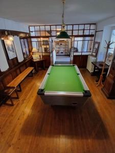 a pool table in the middle of a room at Auberge du Belvédère in Séez