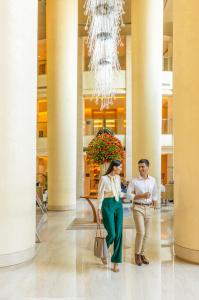 a man and a woman standing in a lobby at Trident Bandra Kurla in Mumbai +65 photos