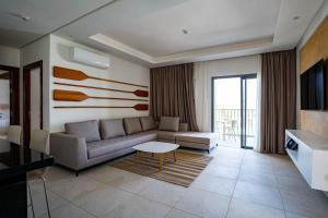a living room with a couch and a table at Zephyr Saidia in Saïdia
