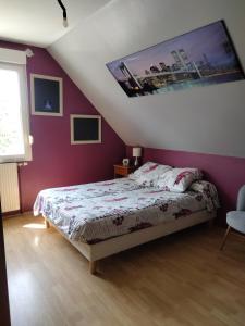 a bedroom with a bed and a purple wall at Les stands 4 chambres - lits doubles in Teloché