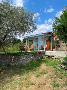 a house with a patio and a chair in the yard at Come a casa B&B in Montegrino Valtravaglia