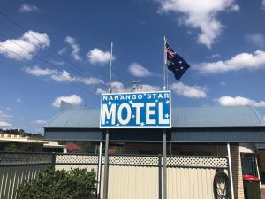 a blue and white sign with a flag on top of it at Nanango Star Motel in Nanango