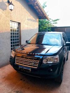 a black car parked in front of a building at Balcony house in Campo Grande