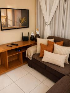 a living room with a couch and a table at Balcony house in Campo Grande