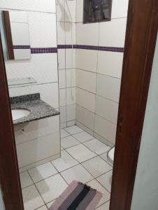 a small bathroom with a sink and a toilet at Balcony house in Campo Grande +8 photos