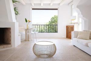 a living room with a white couch and a large window at LUX-Porto Cervo Center Sea View Apartment in Porto Cervo