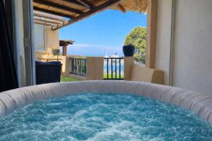 a large plunge pool with a view of the ocean at LUX-Porto Cervo Center Sea View Apartment in Porto Cervo +26 photos