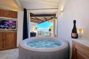 a hot tub in a kitchen with a bottle of wine at LUX-Porto Cervo Center Sea View Apartment in Porto Cervo