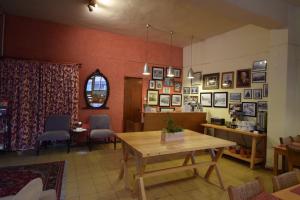 a dining room with a wooden table and chairs at Christys Palace Hotel in Pedoulas