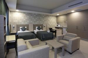 a bedroom with two beds and a living room at Sen Otel in Sakarya +69 photos