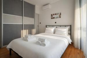 a bedroom with two beds with towels on them at Voula Asklipeio Residence Supreme in Athens