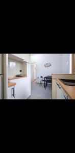a kitchen and a dining room with a table at Voula Asklipeio Residence Supreme in Athens +9 photos