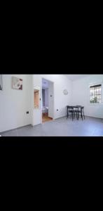 a dining room with a black table in a white room at Voula Asklipeio Residence Supreme in Athens