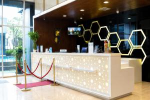 a counter in a store with a red ribbon at Best Western Premier The Hive in Jakarta +33 photos