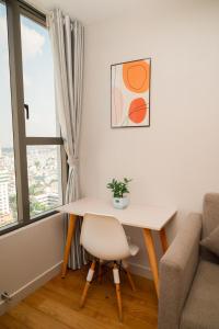 a table and a chair in a room with a window at Sleep & Go Capsule Hostel Bui Vien District 1 in Ho Chi Minh City