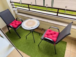 a balcony with two chairs and a table and a table at Apartament Górnicza in Gdynia