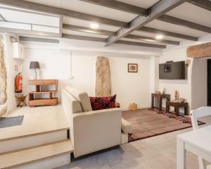 a living room with stairs and a couch and a table at Casa da Caleira in Fonte Arcada