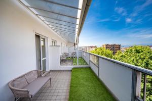 a balcony with a bench and grass at Hotel Miramonti in Turin