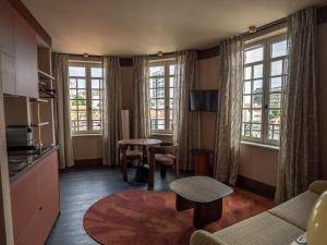 a living room with a couch and a table at Maison Atalaye - Hôtel entièrement rénové in Biarritz