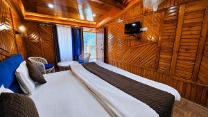 a bedroom with a bed in a wood paneled room at Nainital Hill View Boho in Nainital