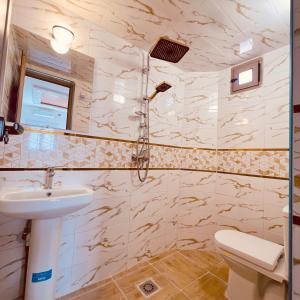 a bathroom with a sink and a toilet at Merzouga Desert Apartment in Merzouga +32 photos