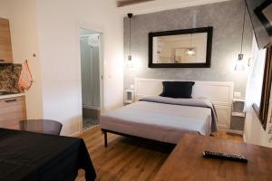 a bedroom with a bed and a mirror on the wall at BluesHouse La Fenice in Bologna