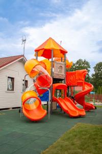 a playground with a slide and a play structure at Wakacje Bobolin in Bobolin