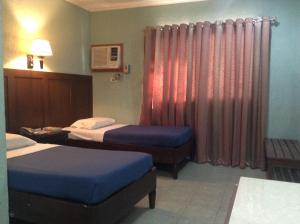 Postel nebo postele na pokoji v ubytování Miami Inn