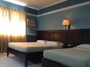 Postel nebo postele na pokoji v ubytování Miami Inn