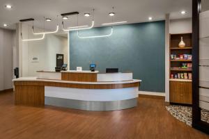 a lobby of a pharmacy with a reception desk at SpringHill Suites by Marriott Buffalo Airport in Williamsville +20 photos