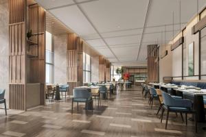 a dining room with tables and chairs in a building at Fairfield by Marriott Kunming Xishan in Kunming