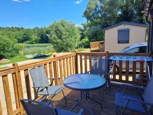 a patio with a table and chairs on a deck at Haus Barsch in Lohmen