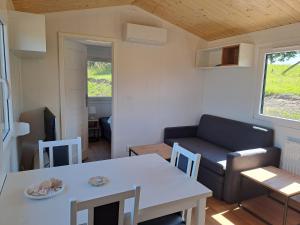 a small living room with a table and a couch at Haus Barsch in Lohmen