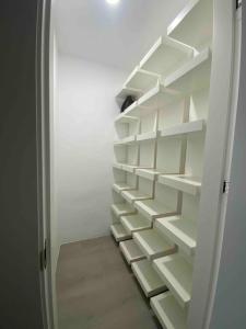 a staircase in a closet with white shelves at Entire 250m2 chalet in Puzol