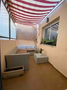 a room with awning and a couch and a window at Entire 250m2 chalet in Puzol +8 photos