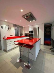 a kitchen with a red counter top in a room at Entire 250m2 chalet in Puzol