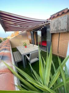 a patio with a table and a patio umbrella at Entire 250m2 chalet in Puzol