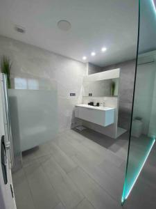 a white bathroom with a sink and a shower at Entire 250m2 chalet in Puzol