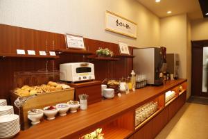a bakery with a counter with food on it at Dormy Inn Kochi in Kochi