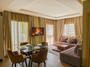 a living room with a table and a couch at Dominium Residence in Agadir