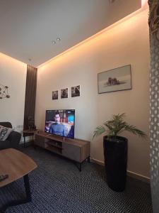 a living room with a flat screen tv on a wall at وحده خاصة بمدخل مباشر s1 in Al Kharj
