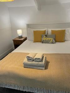 a bedroom with a bed with two towels on it at Bryndegwel in Saint Dogmaels, cardigan- river views, Free parking in Cardigan