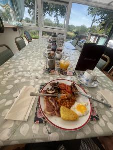 a plate of breakfast food on a table at Cripple Creek Bed And Breakfast in Rowlands Castle