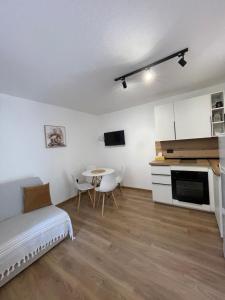 a living room with a bed and a table with chairs at Casa Mare in Prčanj