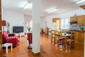 a kitchen and a living room with a table at Vv Casa Marire in Breña Alta