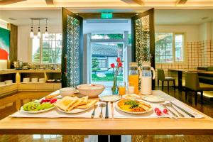 a table with plates of food on top of it at Gold Motel in Puxin