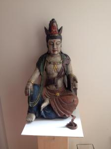 a statue of a deity sitting on a shelf at Appartement am Tegeler See in Berlin