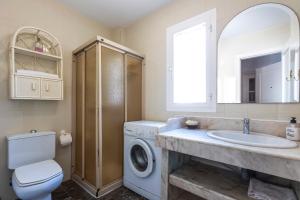 a bathroom with a sink and a washing machine at house las chuchas CALAHONDA in Motril +26 photos